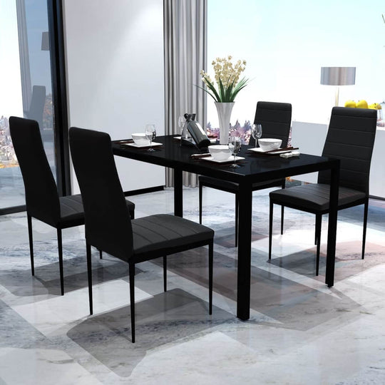 Black five-piece dining table set featuring a tempered glass top and upholstered chairs, set in a modern interior.