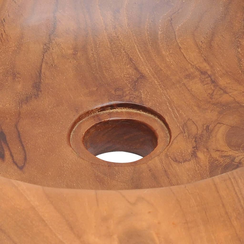 Close-up of a solid teak basin showcasing the handmade craftsmanship and circular drain hole design.