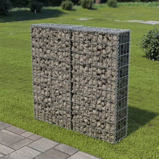 Gabion wall with filled rocks in a landscaped yard, suitable for outdoor furniture and retaining wall applications.