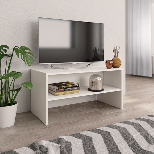 Stylish white TV cabinet made of engineered wood with open storage, showcasing books and decor in a modern living room setting.