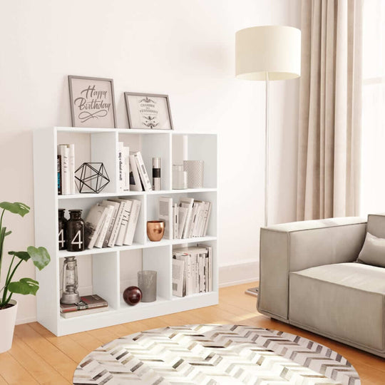 Modern white book cabinet in a cozy living room, showcasing books and decor in 8 spacious compartments.