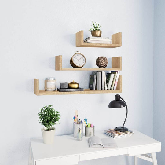 Wall display shelf set of 3 in Sonoma oak with plants, clock, and books, enhancing a stylish workspace.