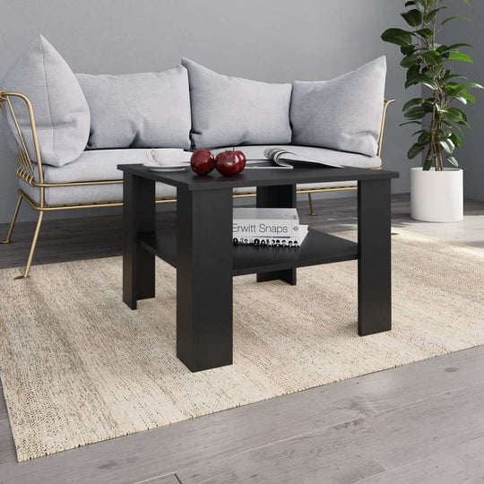 Coffee table in black engineered wood beside a gray sofa, featuring a stable surface and storage shelf, ideal for outdoor lounge settings.