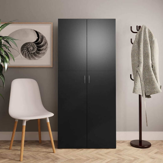 Modern black shoe cabinet next to a chair, with wall art and coat rack in a stylish hallway setting.