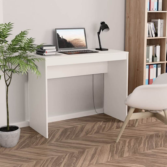 Modern white desk made of engineered wood, ideal for study or office, with laptop and plant, showcasing sleek design.