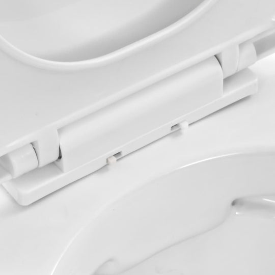 Close-up of the hinge mechanism on a wall-hung rimless toilet in ceramic white, showcasing its sleek design.