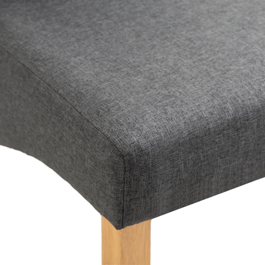 Close-up of grey fabric dining chair seat with wooden legs, ideal for outdoor and home furniture settings.