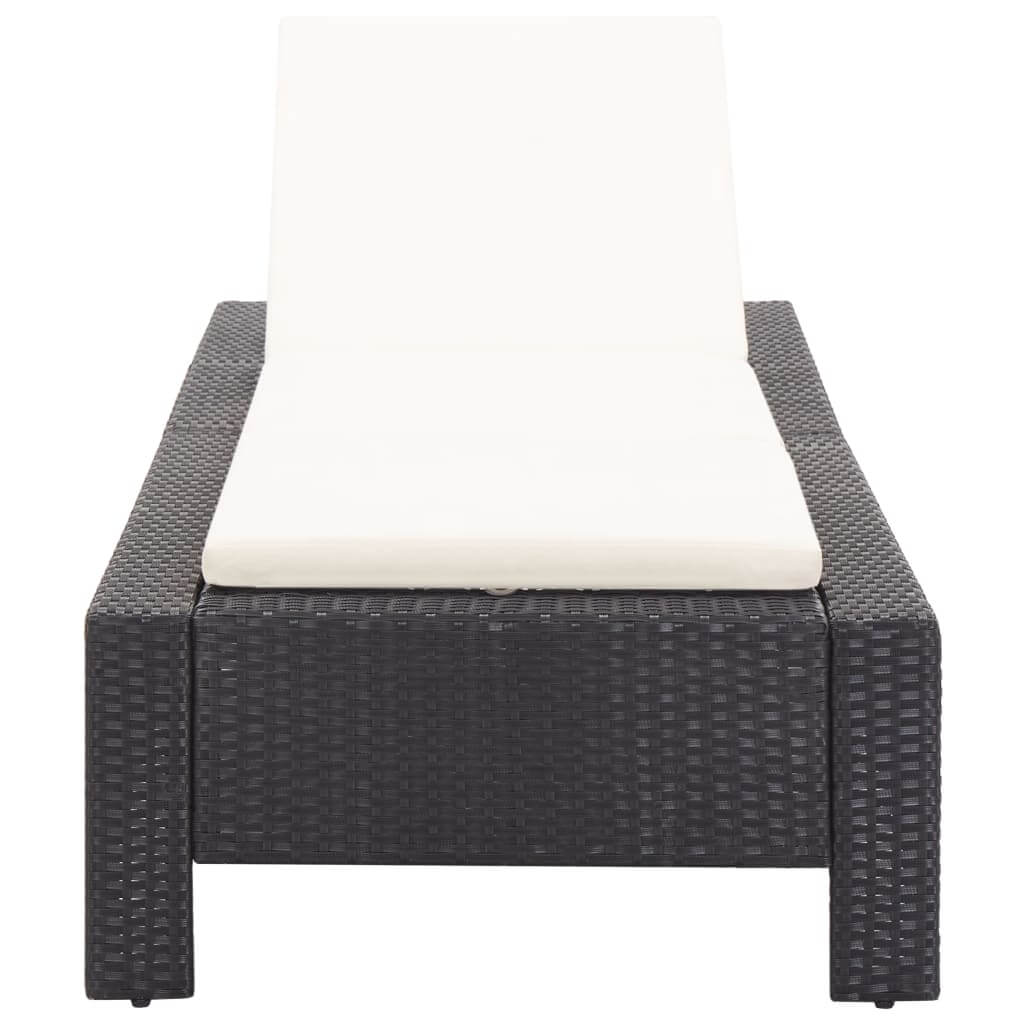 Black poly rattan sunbed with cream cushion, ideal for patios, balconies, and poolside relaxation.