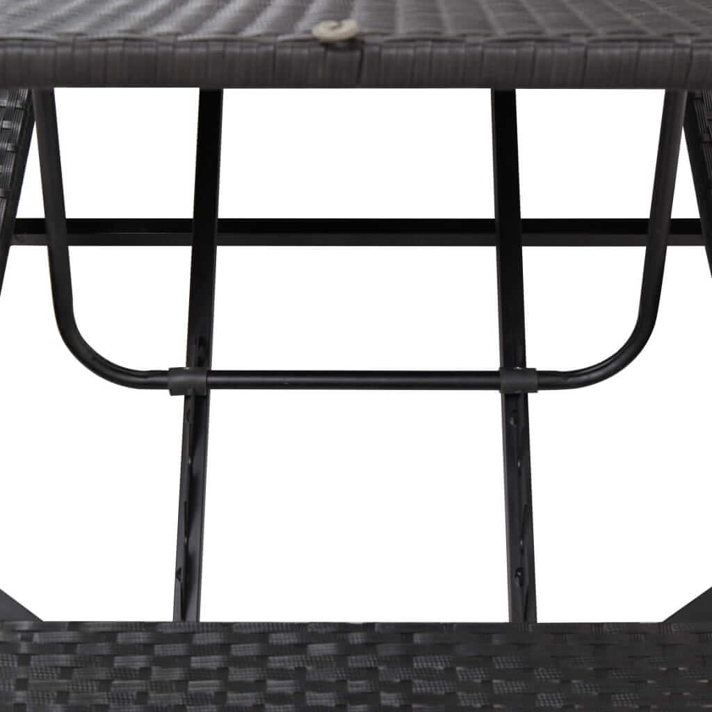 close-up view of the sturdy frame and structure of a black poly rattan sunbed with cushion.