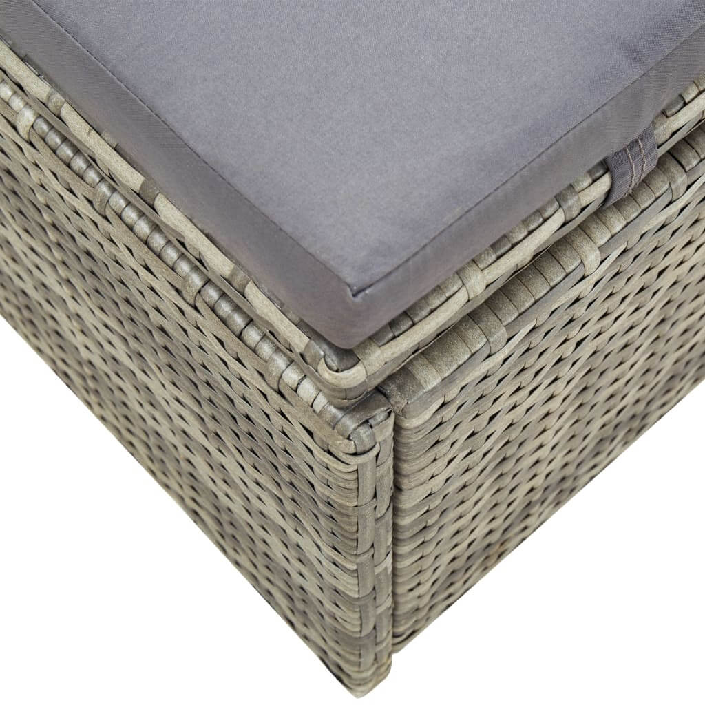 Close-up of a grey poly rattan sunbed with cushion, showcasing its durable weaving and comfortable design.