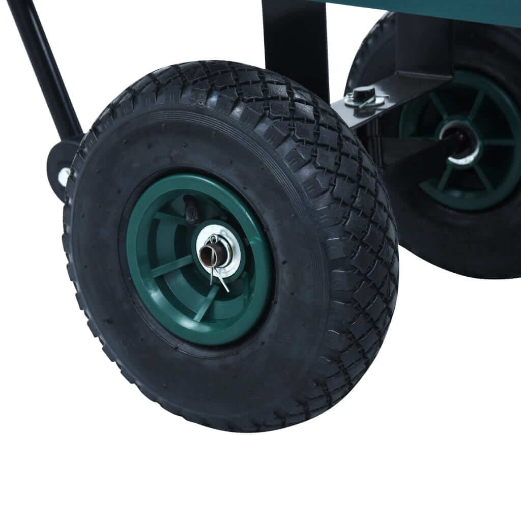 Close-up of a sturdy wheel from a green garden hand trolley designed for heavy loads up to 350 kg.