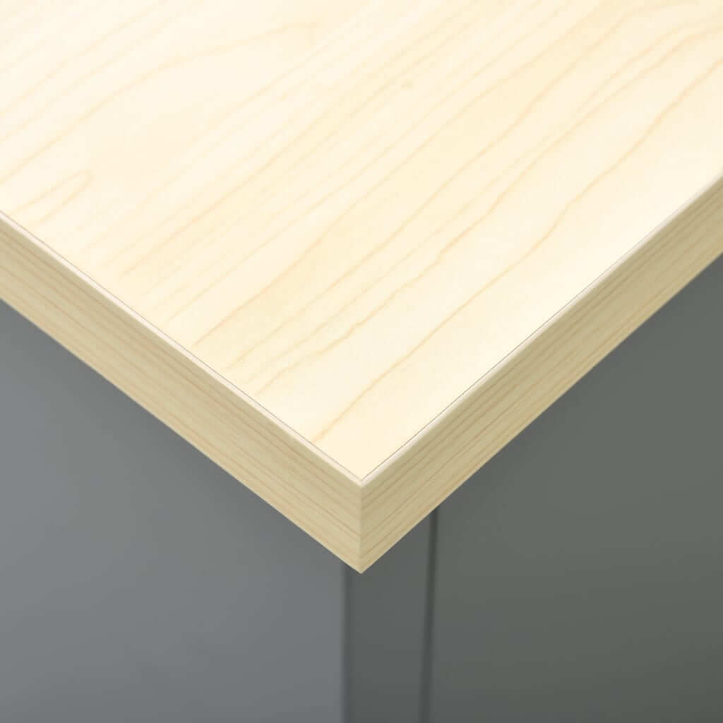 Close-up of a smooth, light wood tabletop edge, showcasing premium craftsmanship and durability for furniture applications.