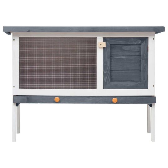 Outdoor rabbit hutch in grey wood with iron wire mesh, ideal for small animals and providing safe play and exercise space.