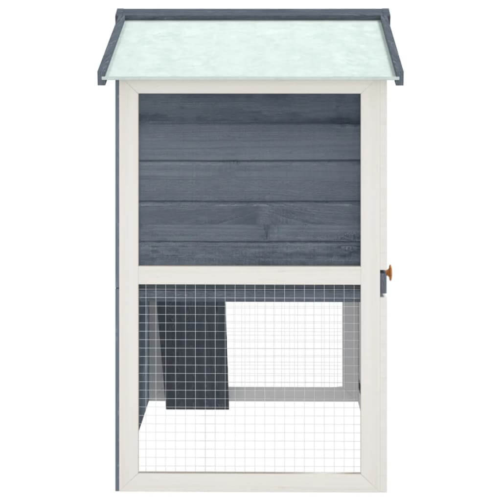 Outdoor rabbit hutch with grey wood finish and mesh door for small animals, providing a safe and cozy space.