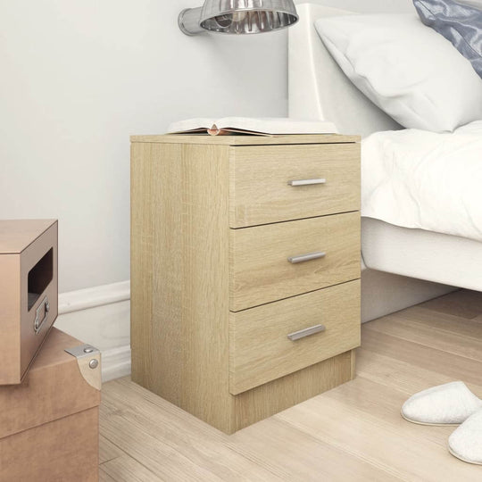 Bedside cabinet in Sonoma Oak with three drawers, perfect for storing books and essentials next to a bed.