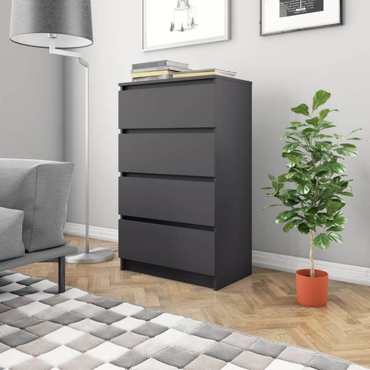 Grey sideboard with four drawers in modern living room setting, decorated with books and potted plant.