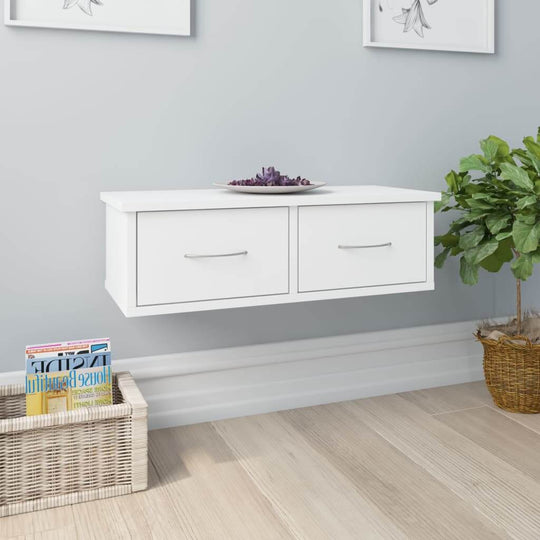 Wall-mounted white drawer shelf with two drawers, perfect for stylish storage and display in any home.