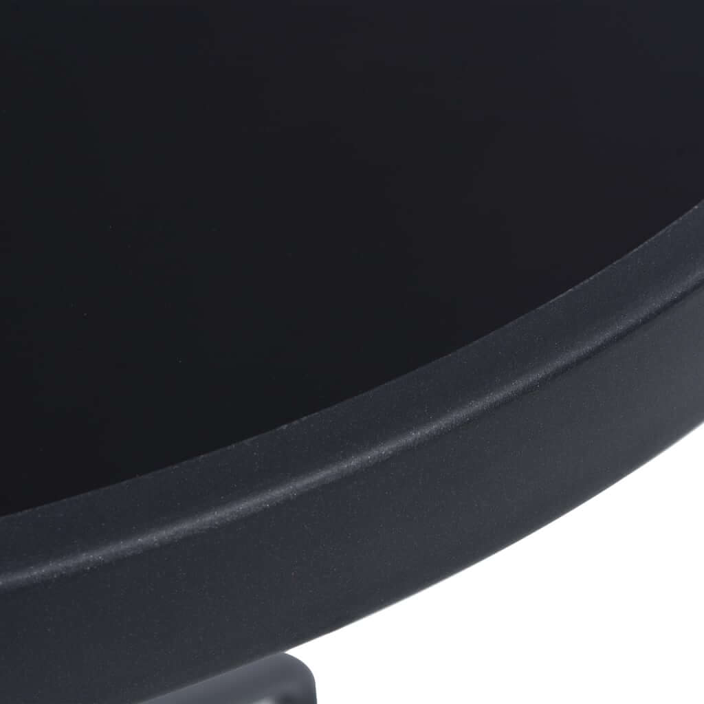 Round black glass top of a garden table showcasing sleek design and durable finish for outdoor furniture.