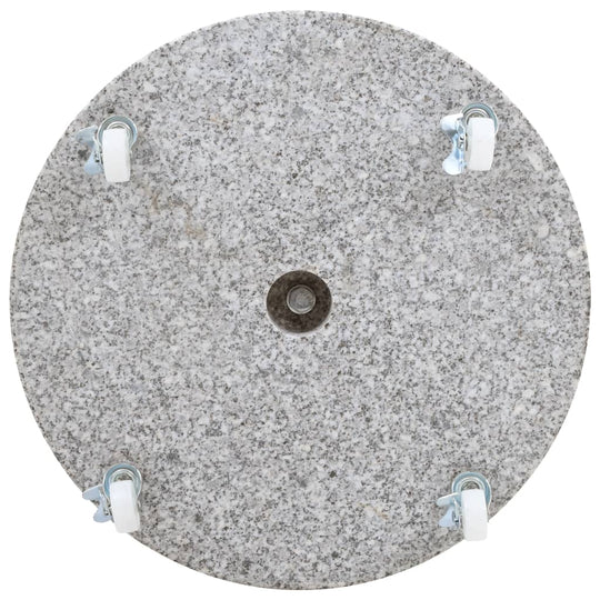 Round grey granite parasol base with four locking wheels for outdoor furniture stability.