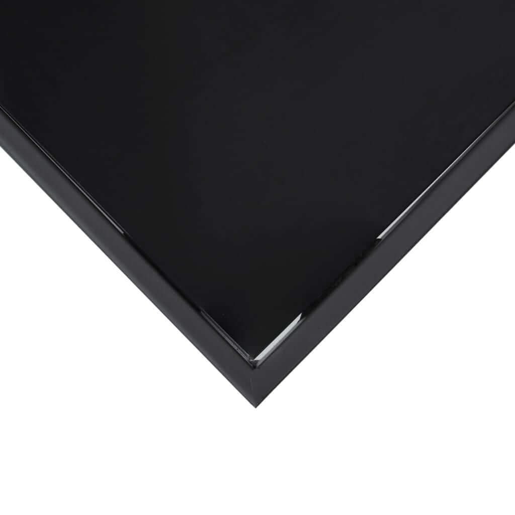 Close-up of black tempered glass tabletop corner, ideal for outdoor furniture and easy cleaning.