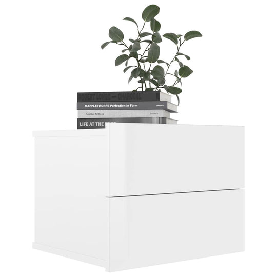 High gloss white bedside cabinet with 2 drawers, books, and a plant on top, showcasing modern minimalist design.