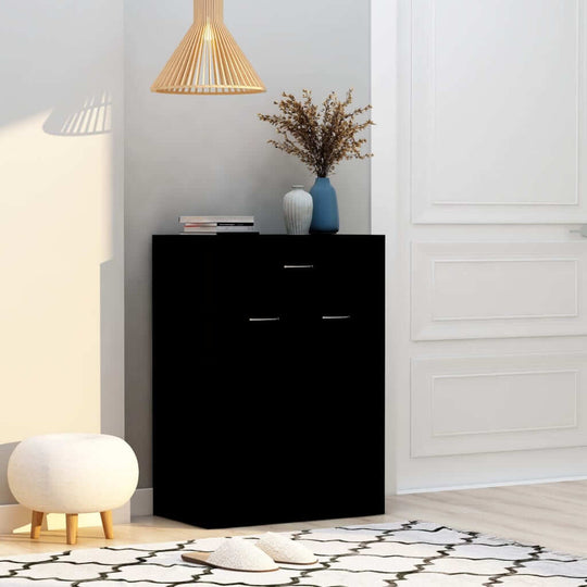 Black shoe cabinet with two drawers and decorative items, perfect for organizing shoes and enhancing living spaces.