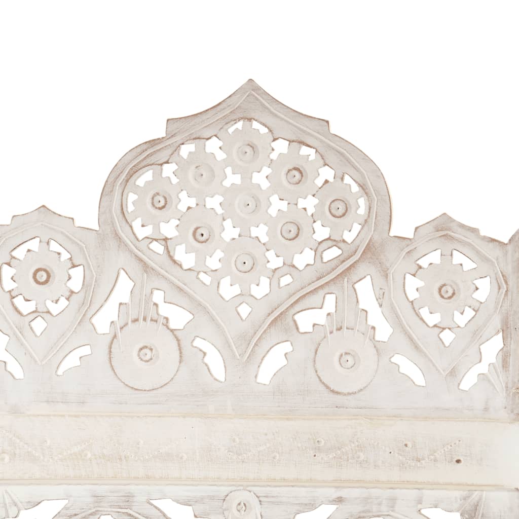 Hand carved wooden panel detail of a white room divider showcasing intricate floral patterns.