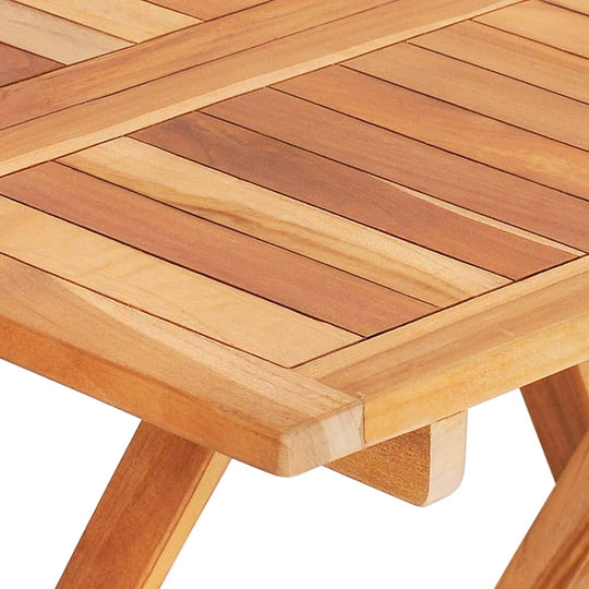 Close-up of a folding bistro table surface made from smooth solid teak wood, showcasing elegant wood grain details.