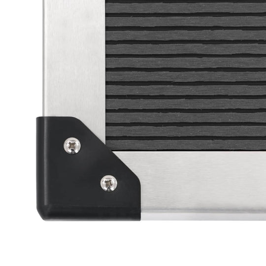 Close-up of the corner of the Outdoor Shower with Tray WPC Stainless Steel showing stainless steel and black detail.
