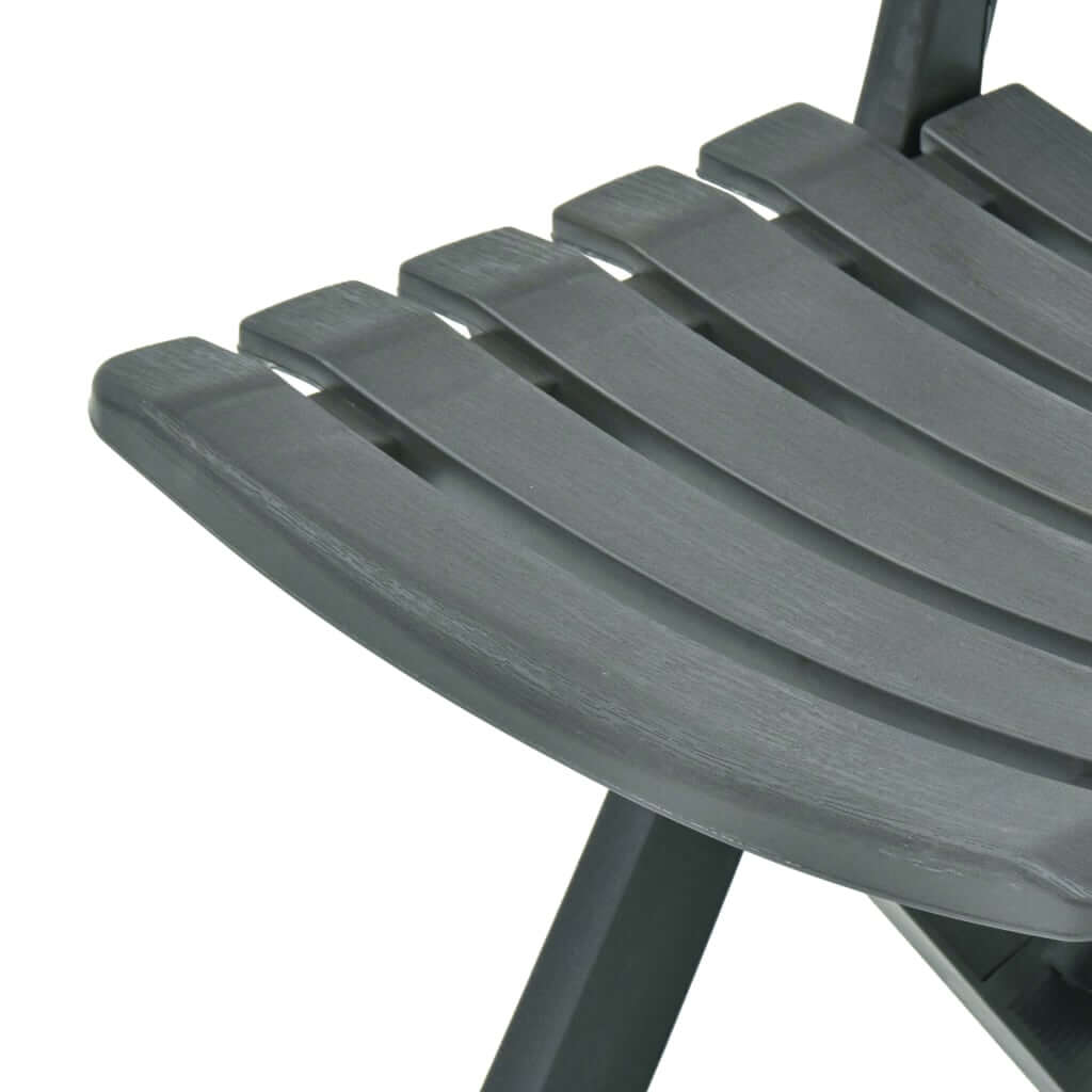 Close-up of the slatted seat design of a weather-resistant folding garden chair in dark gray plastic.