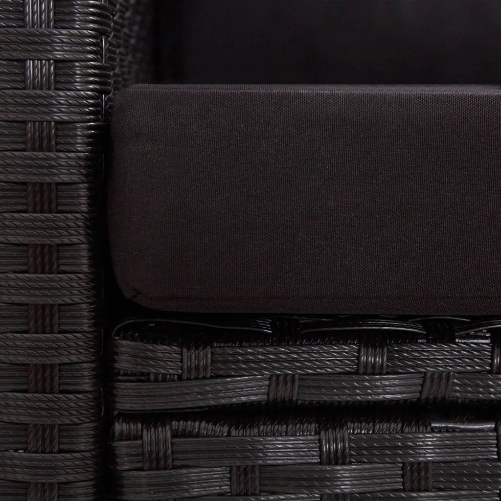 Close-up of black cushioned seating on a 2-seater garden sofa made of weather-resistant poly rattan.