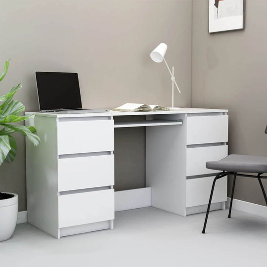 White engineered wood writing desk with six drawers, ideal for small offices, featuring a laptop and book in a compact setup.