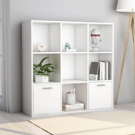 White book cabinet with open cubes and doors, perfect for organizing books and decor in a contemporary living space.