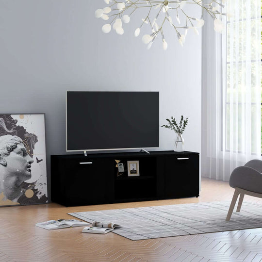 Stylish black TV cabinet with compartments, modern decor, and a flat-screen TV in a bright living room setting.