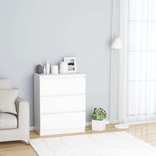 Minimalist white sideboard with three drawers, styled in a modern living room with decorative accents and natural light.