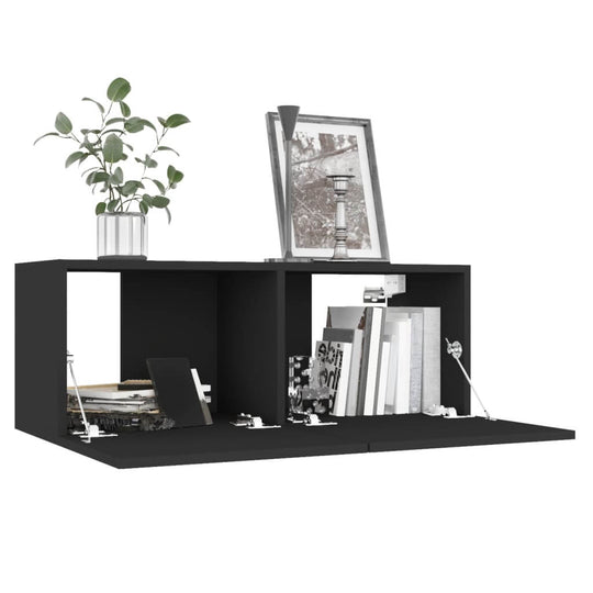 Stylish black TV cabinet with two compartments, decorative plant, and framed picture, ideal for modern living spaces.