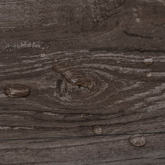 Close-up of PVC flooring with a striped wood design and water droplets, showcasing its waterproof properties.