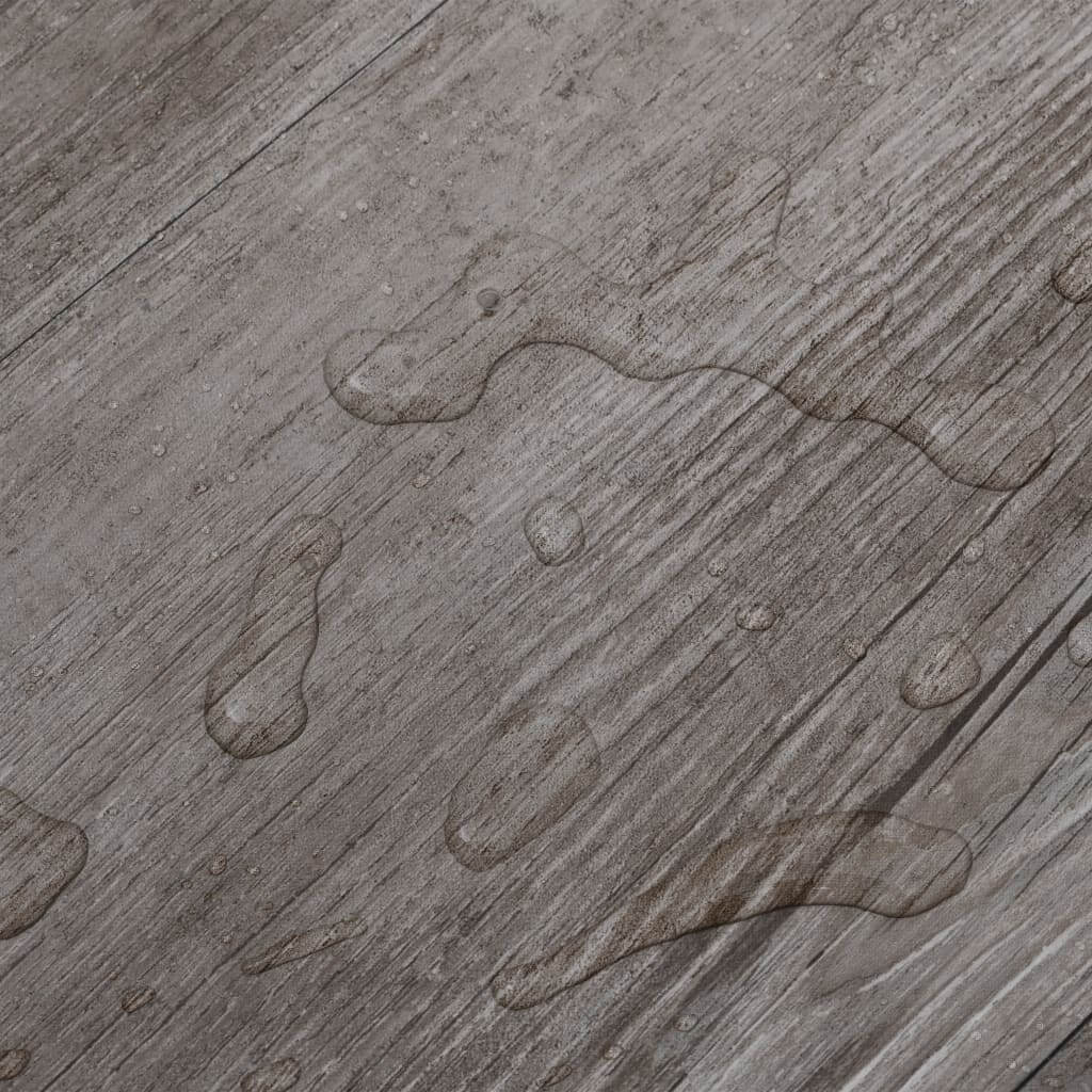 PVC flooring planks surface showing water resistance with droplets on a brown wood-like finish.