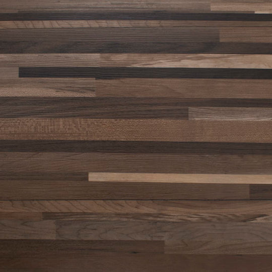 Self-adhesive PVC flooring planks in striped brown design, showcasing a variety of wood tones and textures.