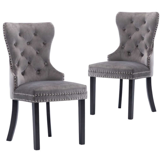 Grey velvet dining chairs set with button tufting and metal rivets, perfect for classic home decor and comfort.