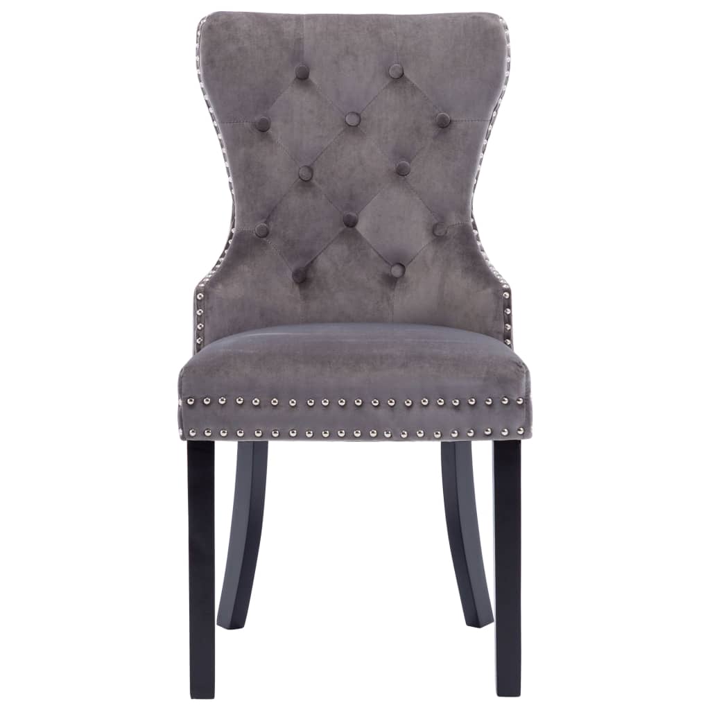 Grey velvet dining chair with button tufting and metal rivets, supported by solid rubberwood legs, perfect for classic decor.