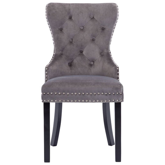 Grey velvet dining chair with button tufting and metal rivets, supported by solid rubberwood legs, perfect for classic decor.