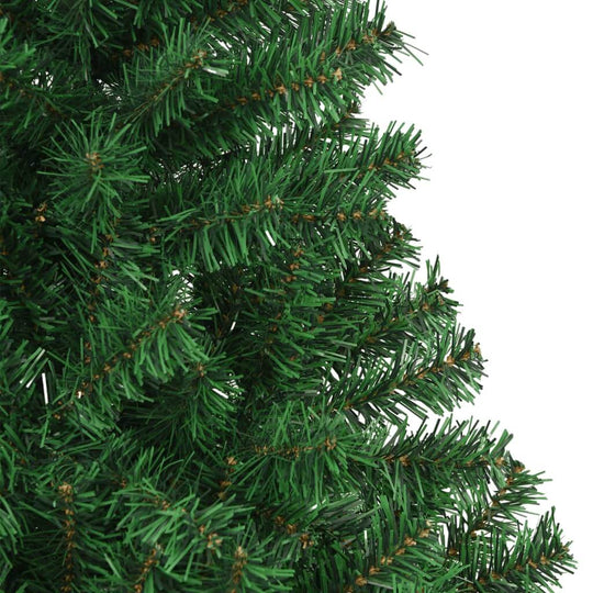 Close-up of thick green branches on an artificial Christmas tree, showcasing its lifelike PVC material and realistic appearance.