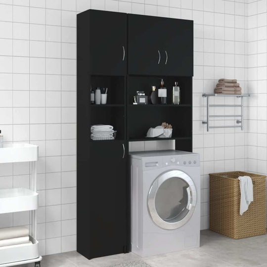 Black bathroom cabinet with shelves and washing machine in modern tiled bathroom setting.