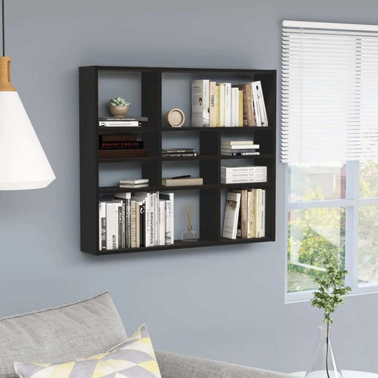 Black wall shelf displaying books and decor, perfect for modern furniture and enhancing any lounge or living space.