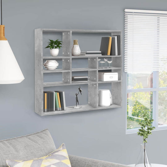 Stylish concrete grey wall shelf with 10 compartments, displaying books and plants in a modern living space.