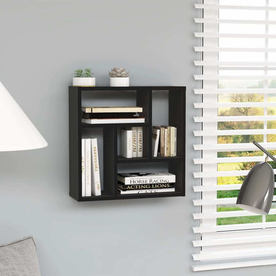 Black wall shelf with five compartments displaying books and decor, ideal for modern furniture arrangements.