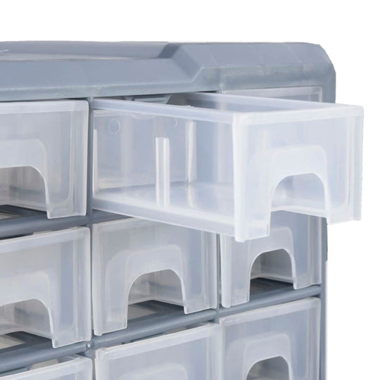 Close-up of a multi-drawer organiser with one clear drawer open, showcasing storage for tools and accessories.