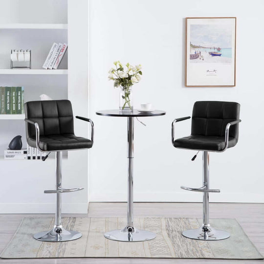 Modern black faux leather bar stools with chrome legs in stylish home setting, perfect for outdoor or indoor living spaces.