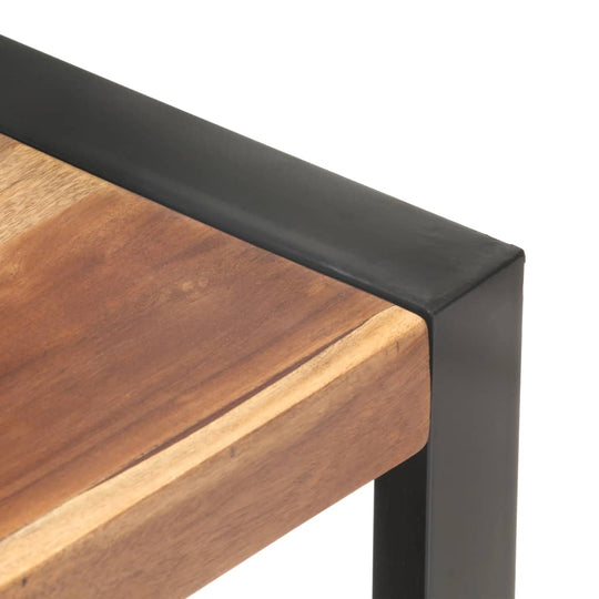 Close-up of a rugged wooden table edge with a black metal frame, highlighting durability and vintage design.